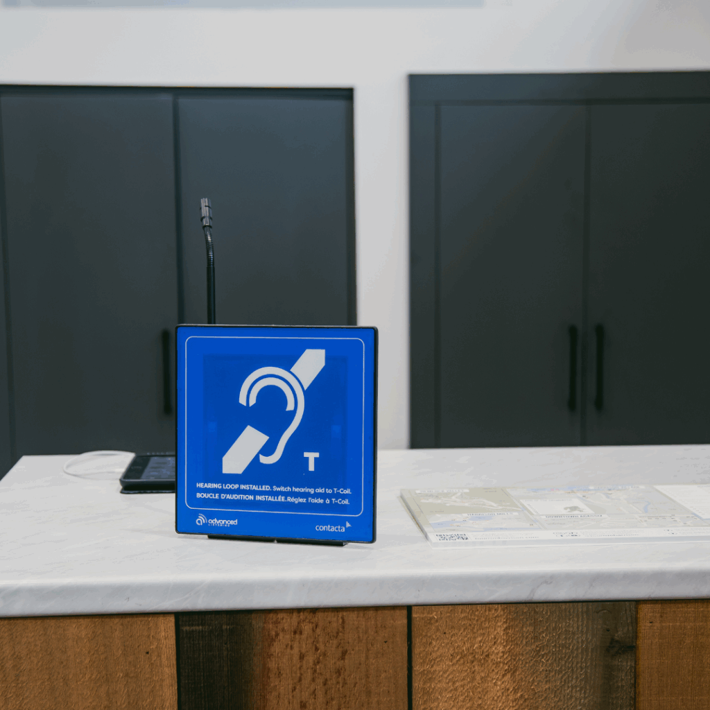 A sign that says "Hearing Loop Installed. Switch hearing aid to T-Coil."