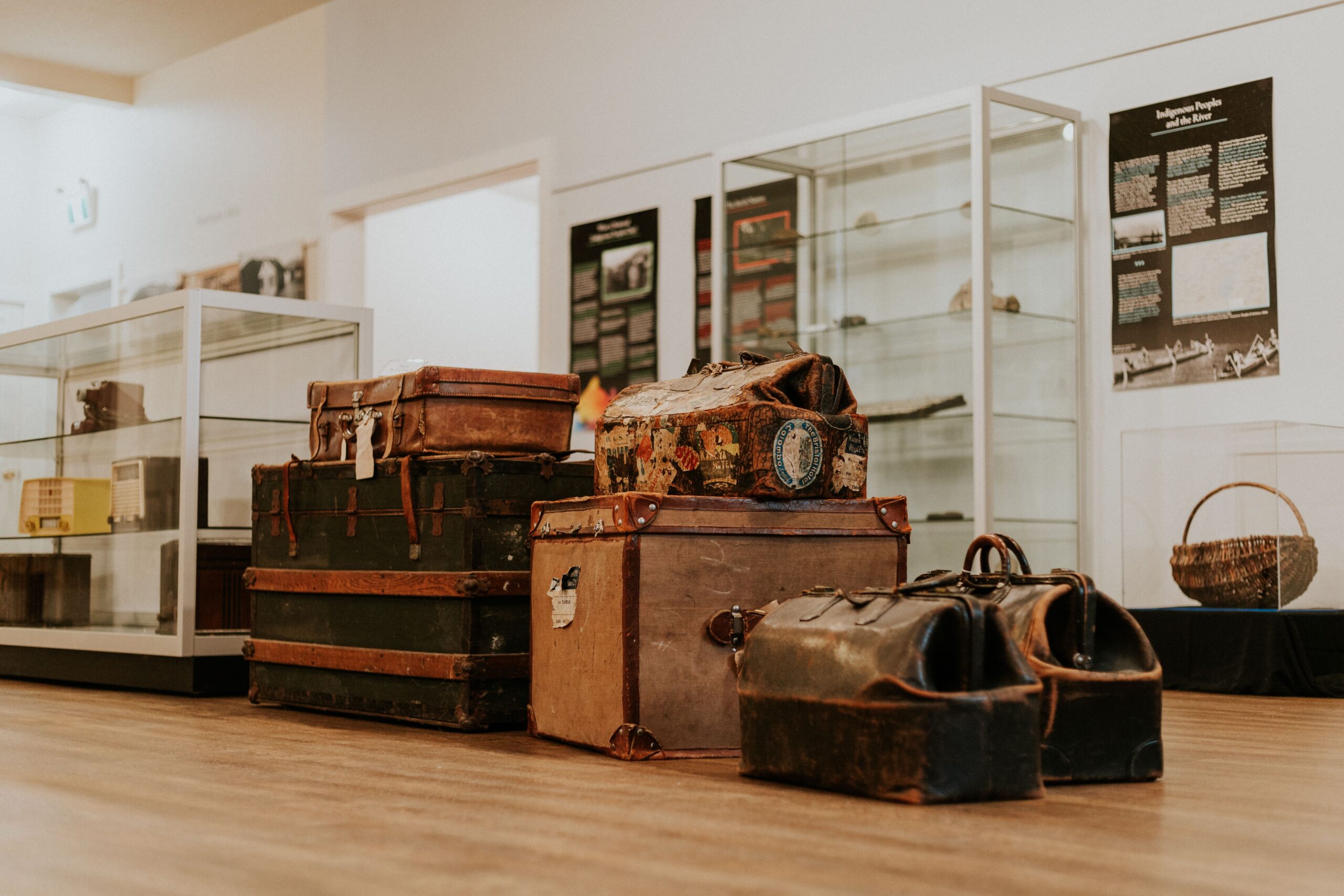 A room filled with vintage suitcases and bags from the past, creating a nostalgic atmosphere.
