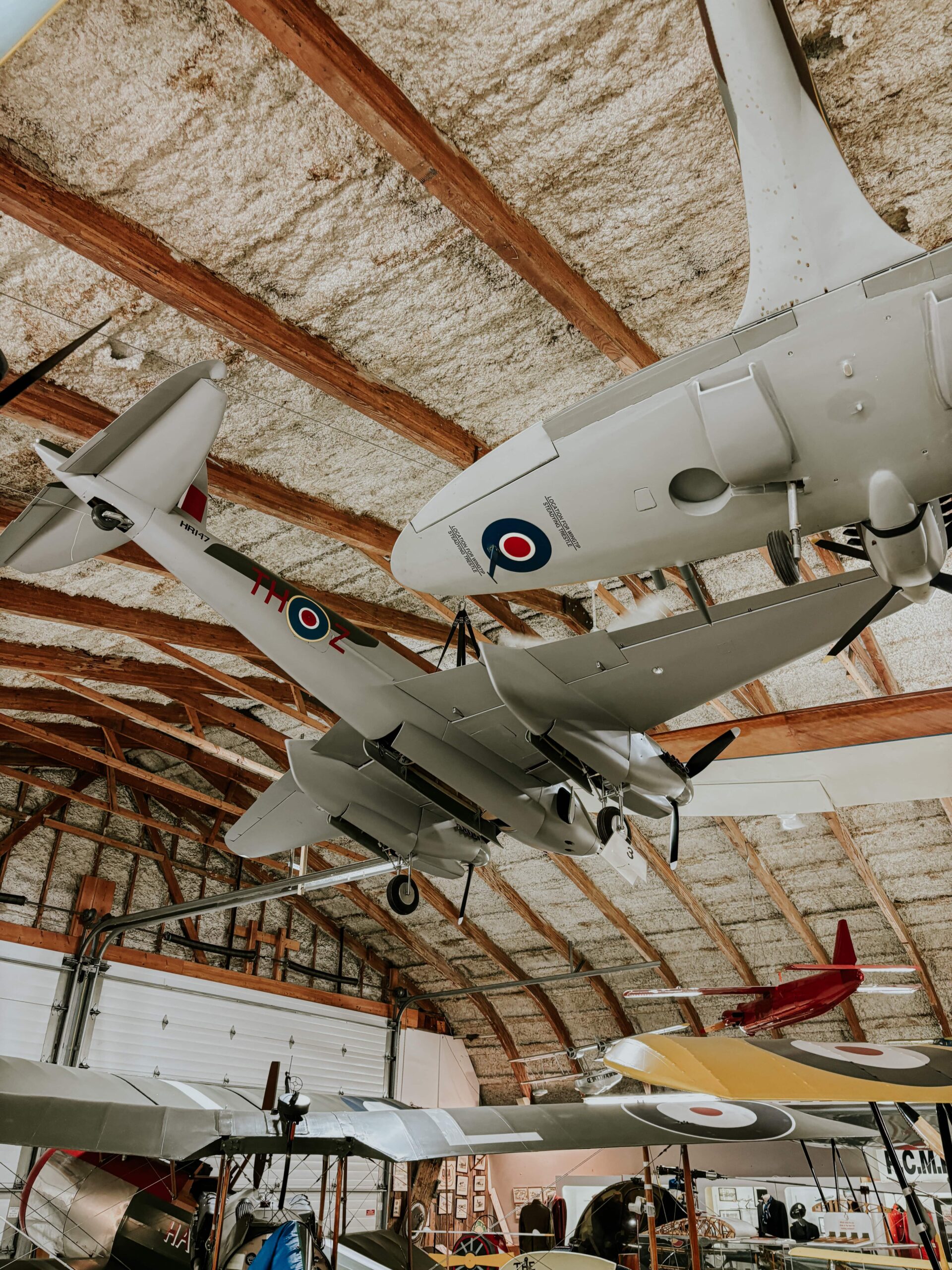 A grey war plan hanging from the ceiling of a museum on display