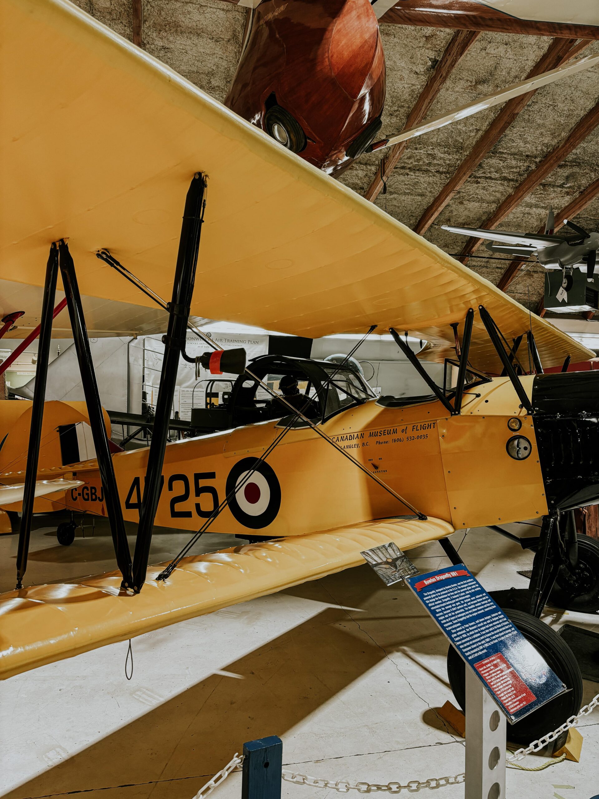 A yellow, older model plane on display