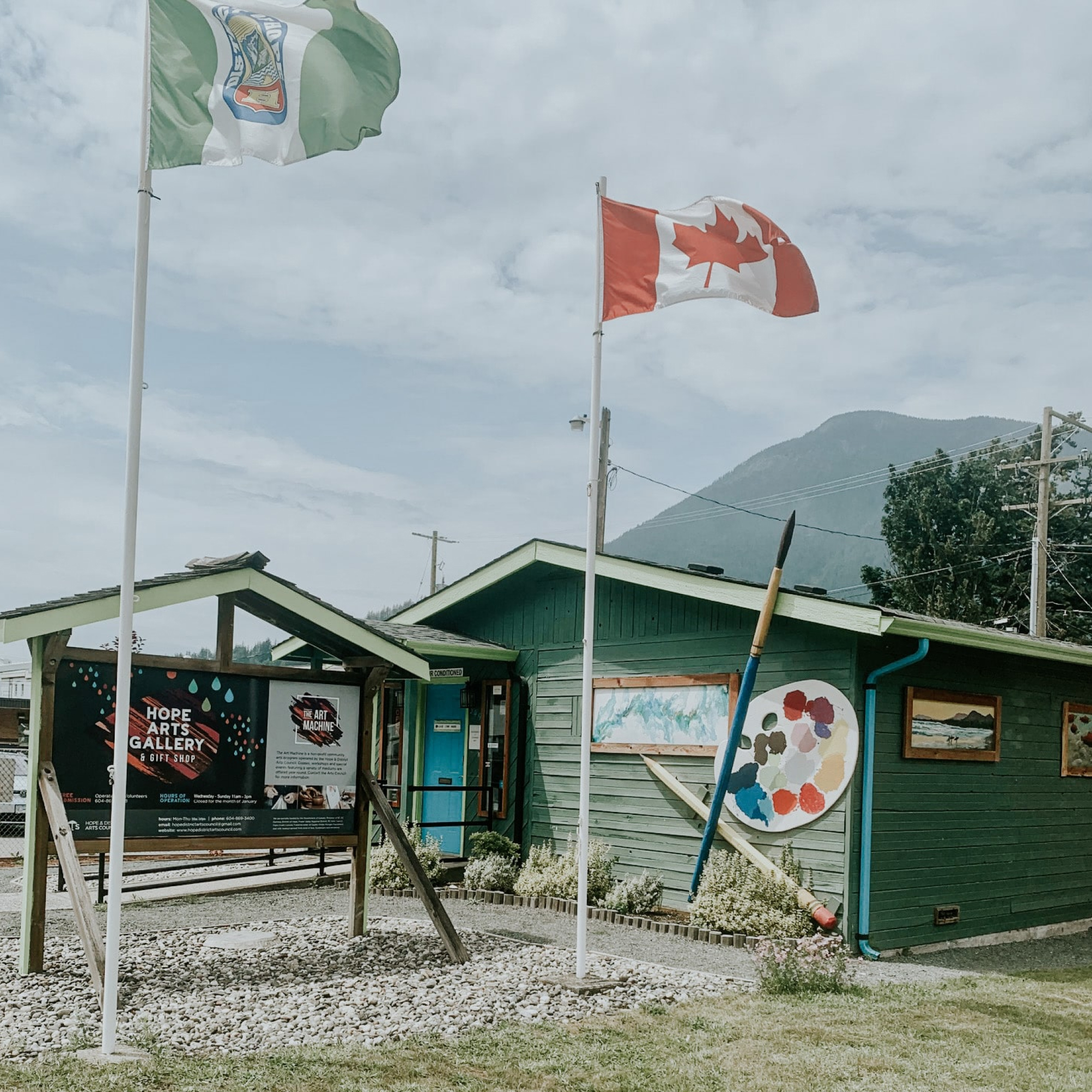A small building adorned with Canadian flags and a flag pole, representing Canadian pride and patriotism.