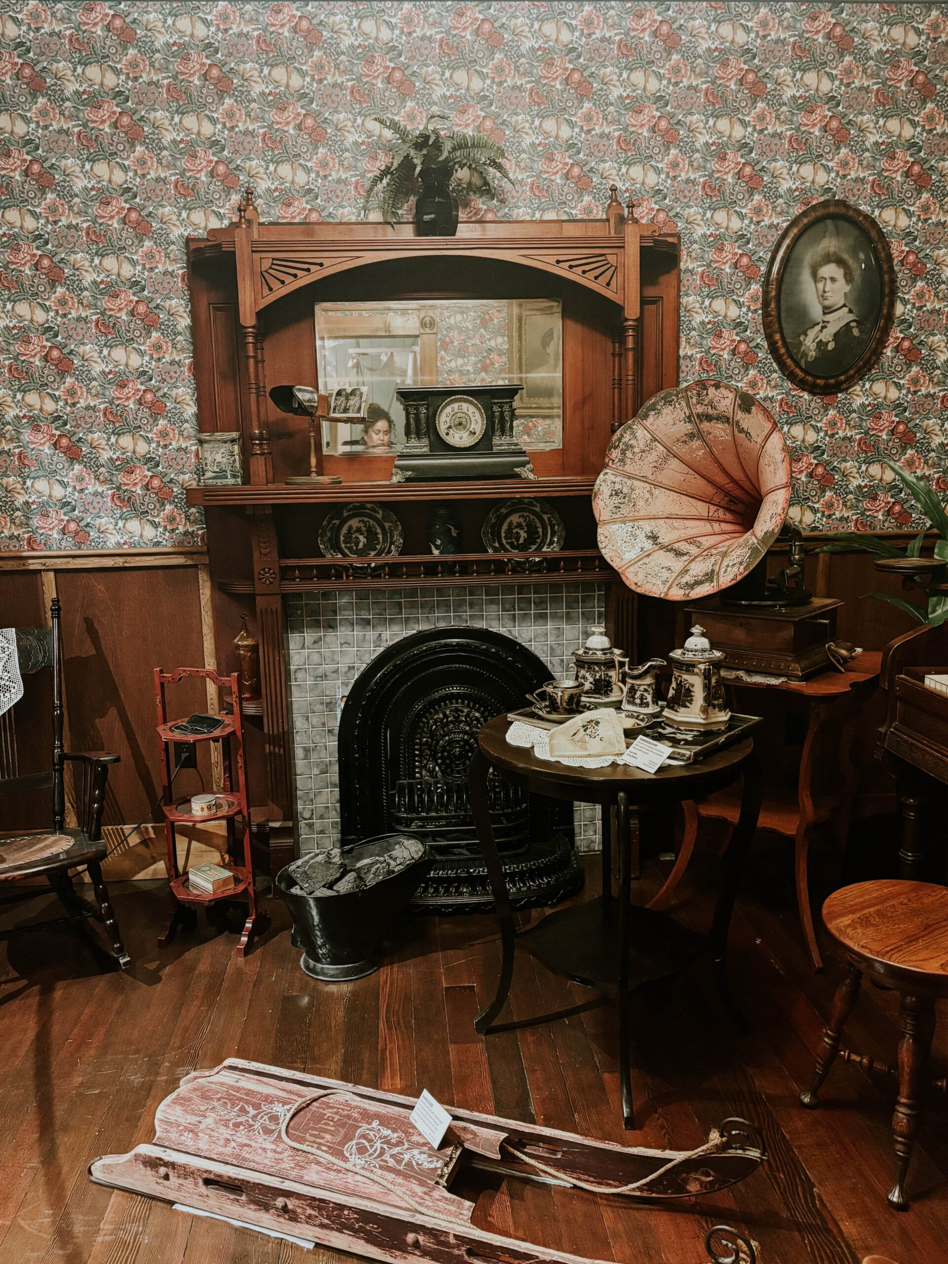 An antique fireplace, with various antique items surrounding it.