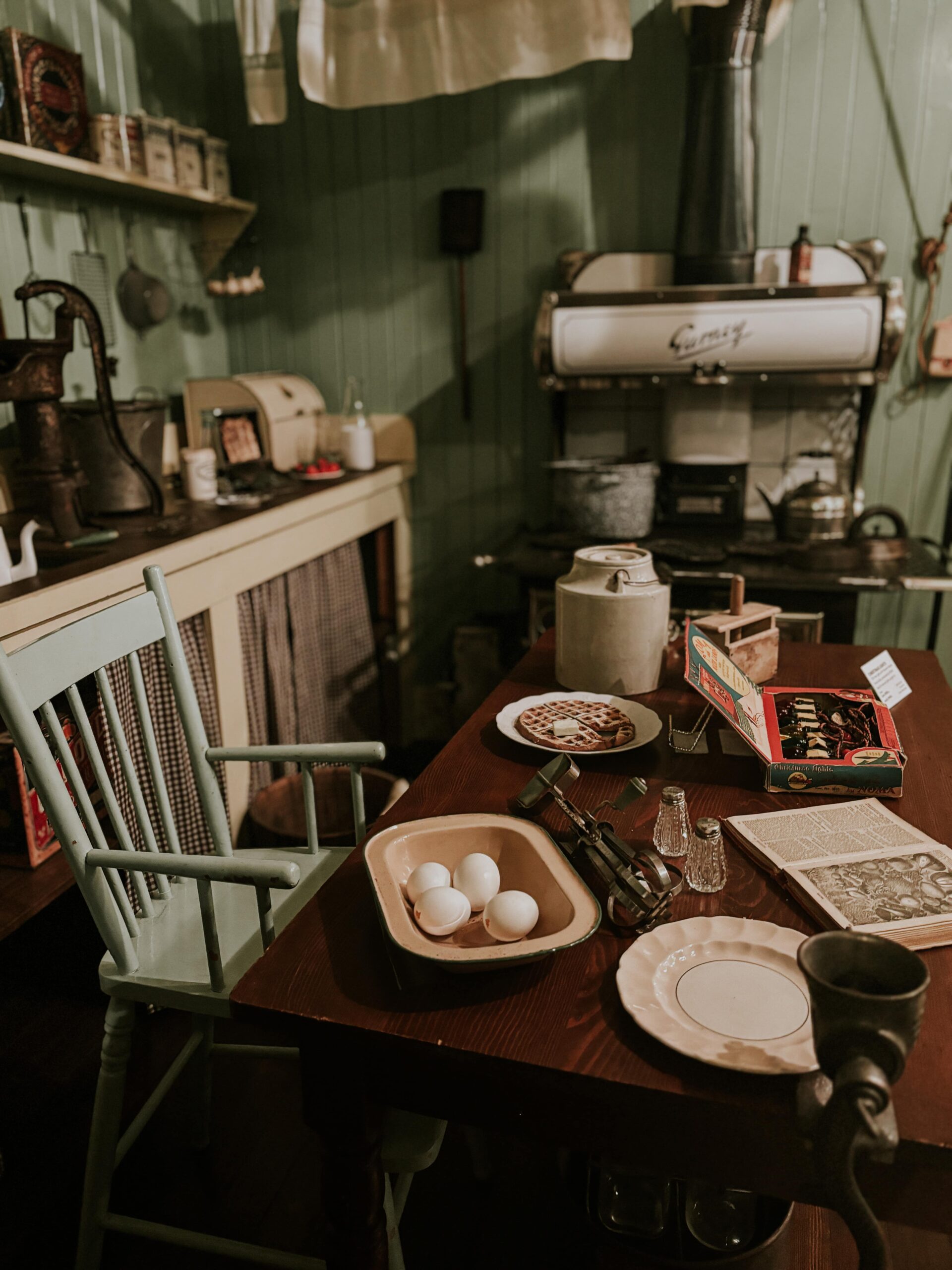 An antique kitchen table, with various display items on it