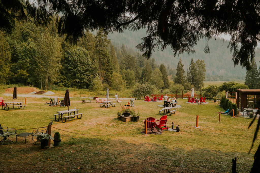 A long shot of the cidery's yard is show, with vibrant patio furniture and yard games.