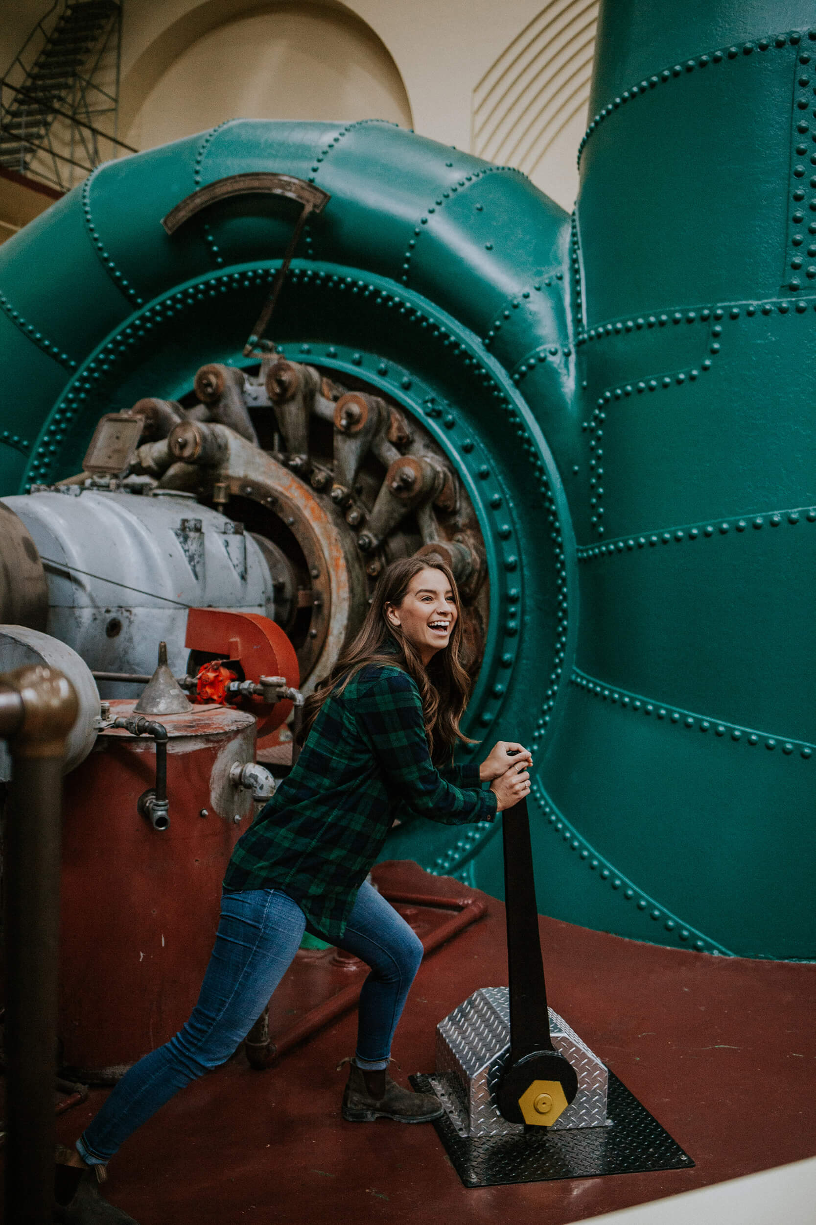 A women pushes a lever at the Stave Falls Powerhouse