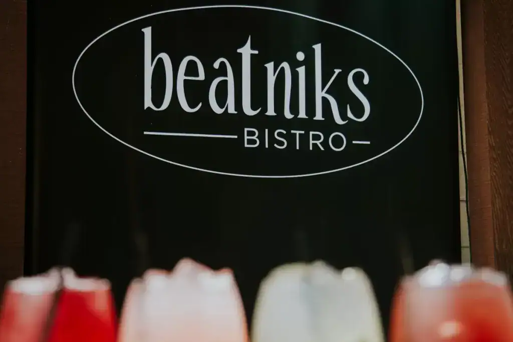 A window decal that says "Beatniks Bistro".