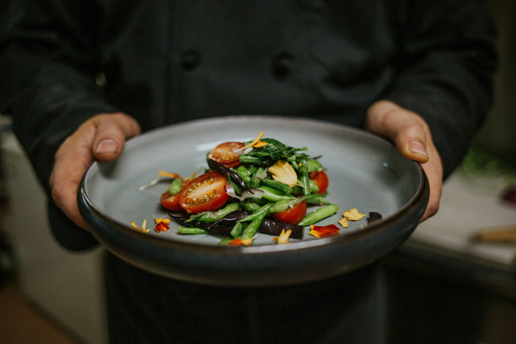 A person holds a plate of food.