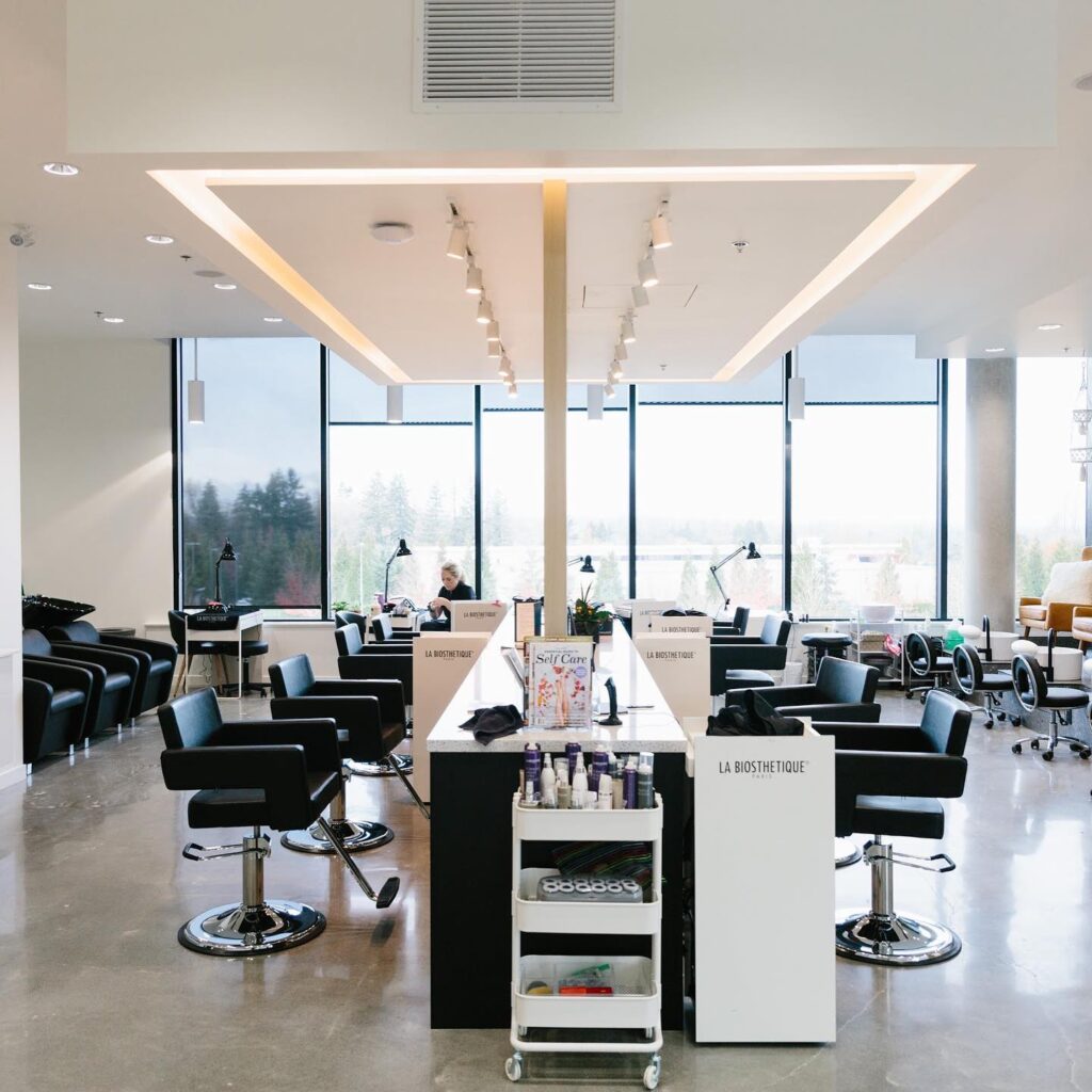 A salon with chairs and mirrors.