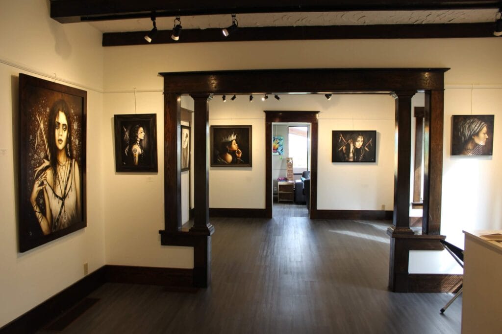 The inside of the Mission Arts Council and Gallery, which features artwork on white walls.