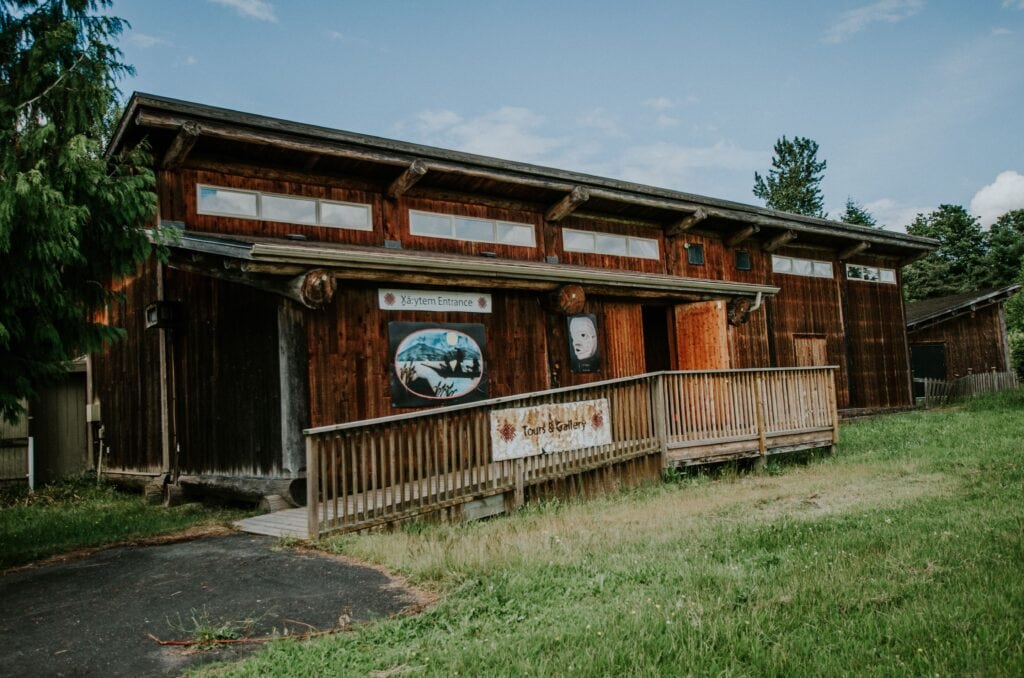 The front of X̲áːytem National Historic Site, which is a small wooden building with a front porch.