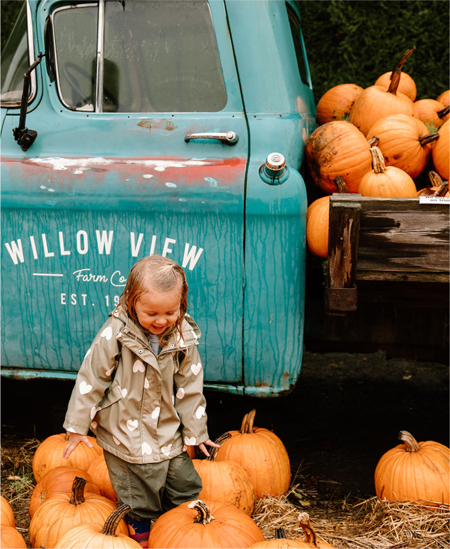 Child with Pumpkins Willowview Farms
