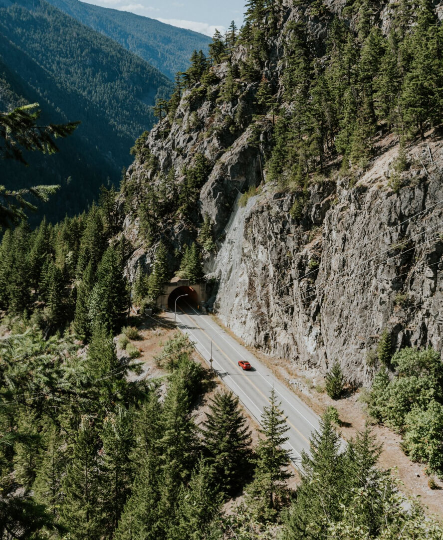 Hope Aerial View Of A Highway With Mountain Cliffs On The Side