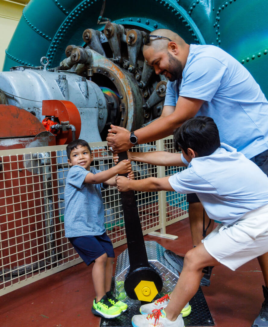 Mission Dad And Sons Play With Lever At Powerhouse