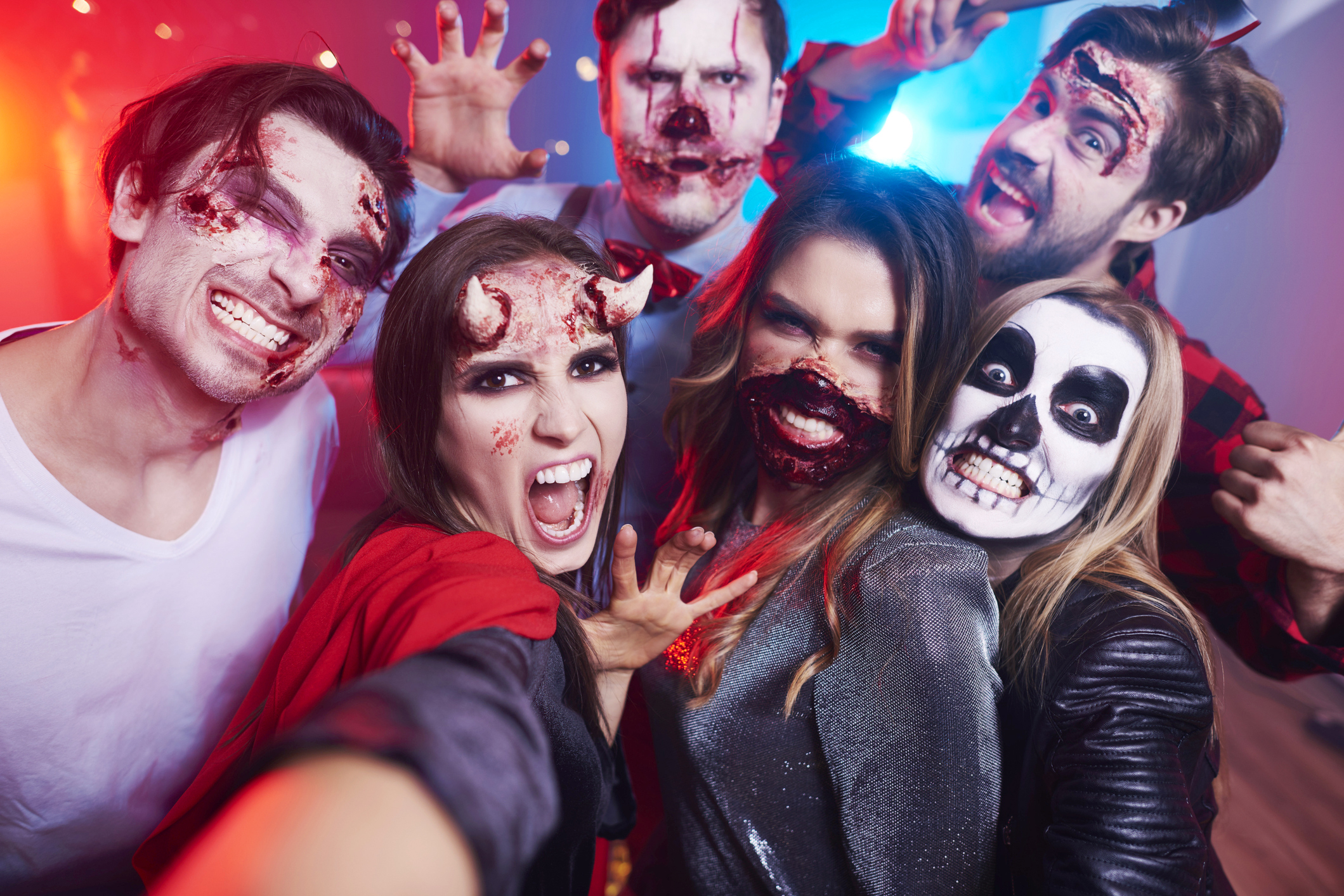 Friends In Creepy Costumes Having Fun At Halloween Party