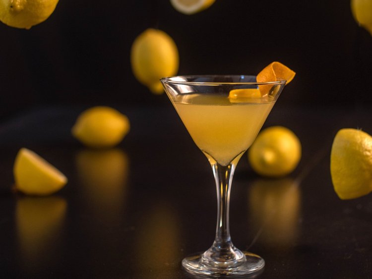 Lemon cocktail close up over a black backdrop