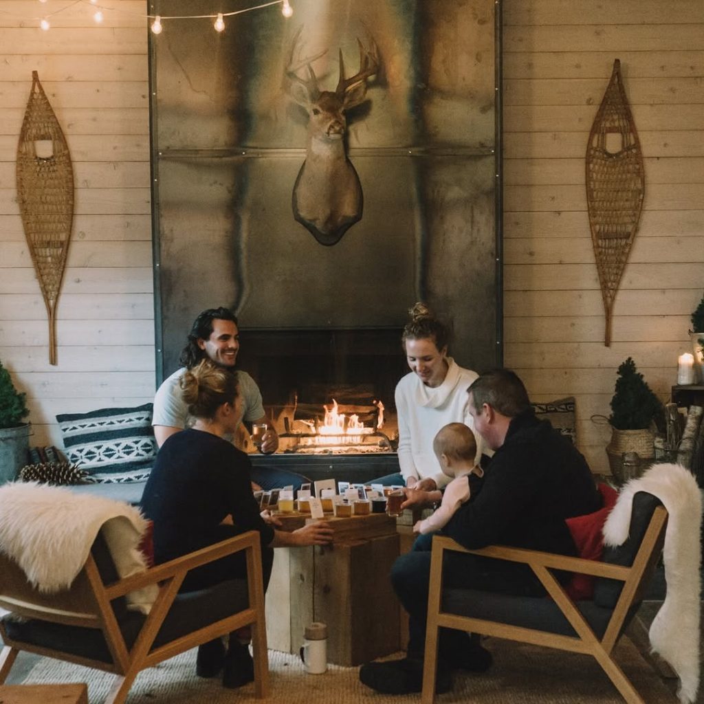 people in front of a fireplace at a brewery