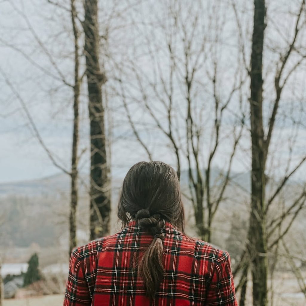 person facing a winter forest