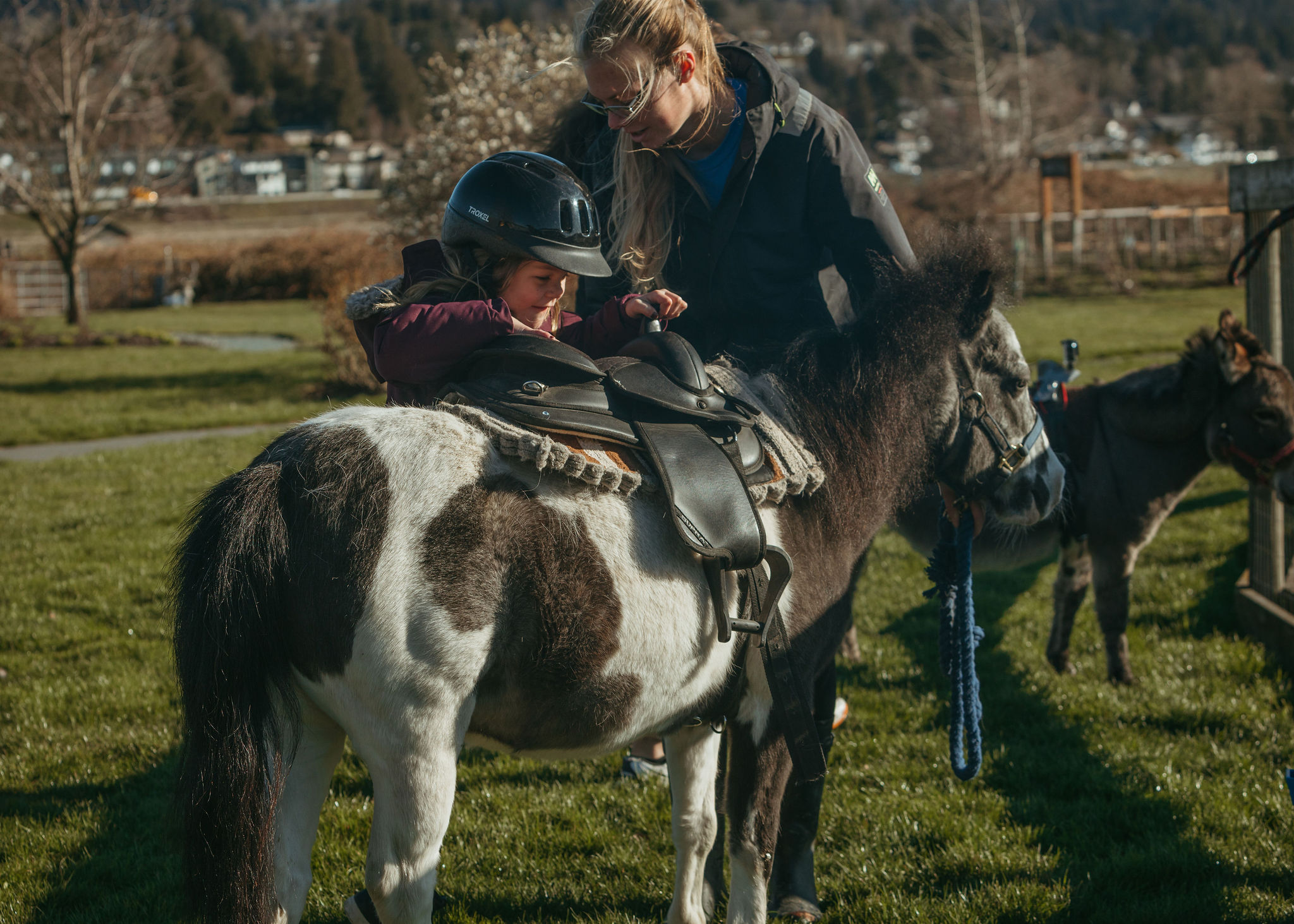 girl getting on a pony