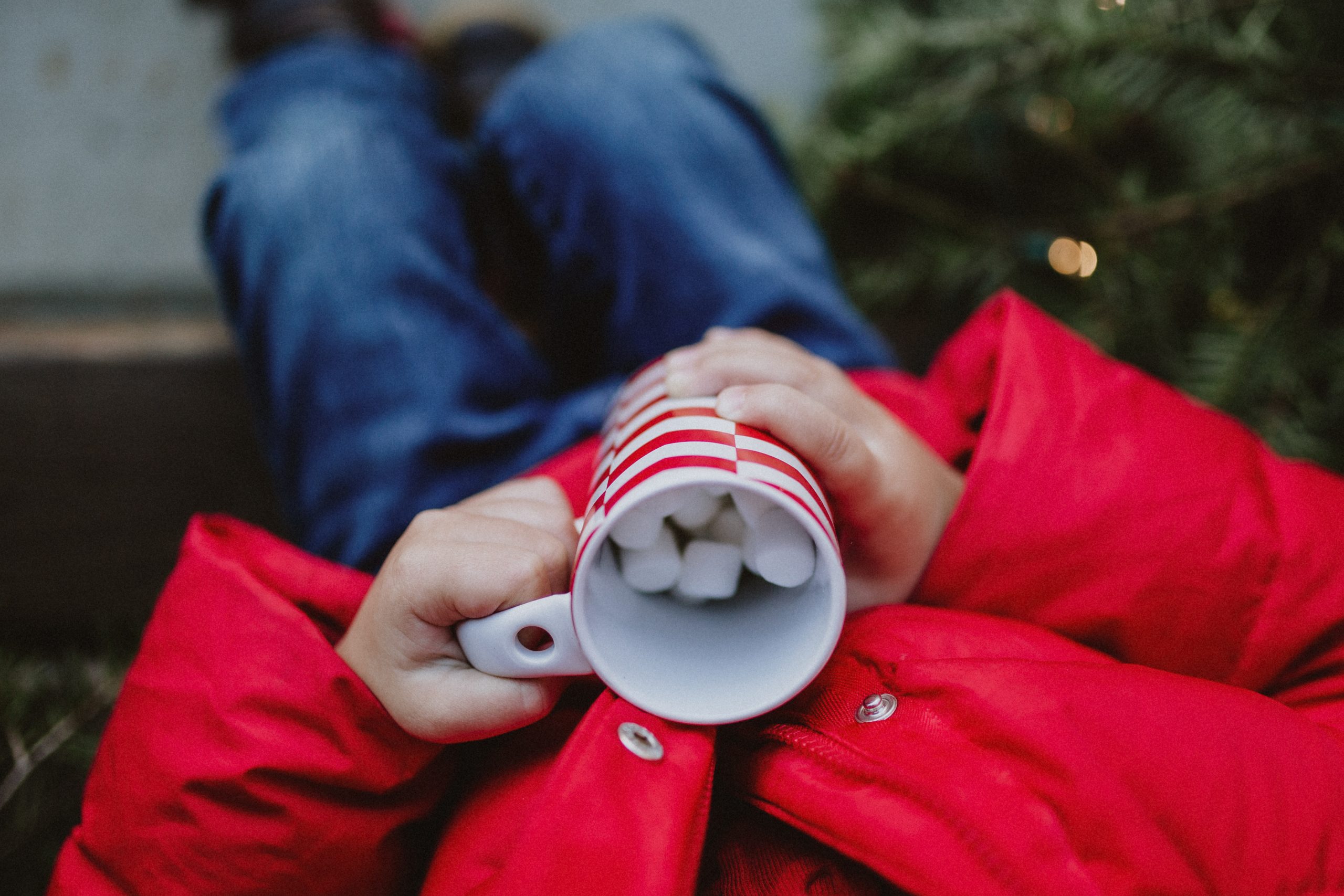 child holds hot chocolate