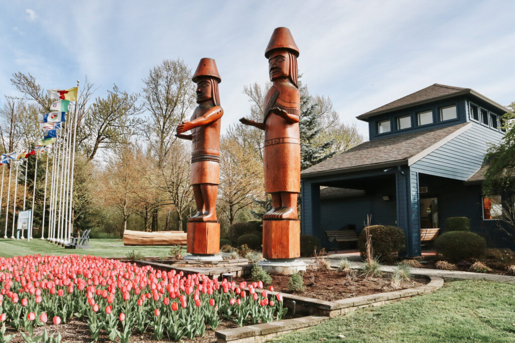 two totem poles in front of the Chilliwack Visitor Centre