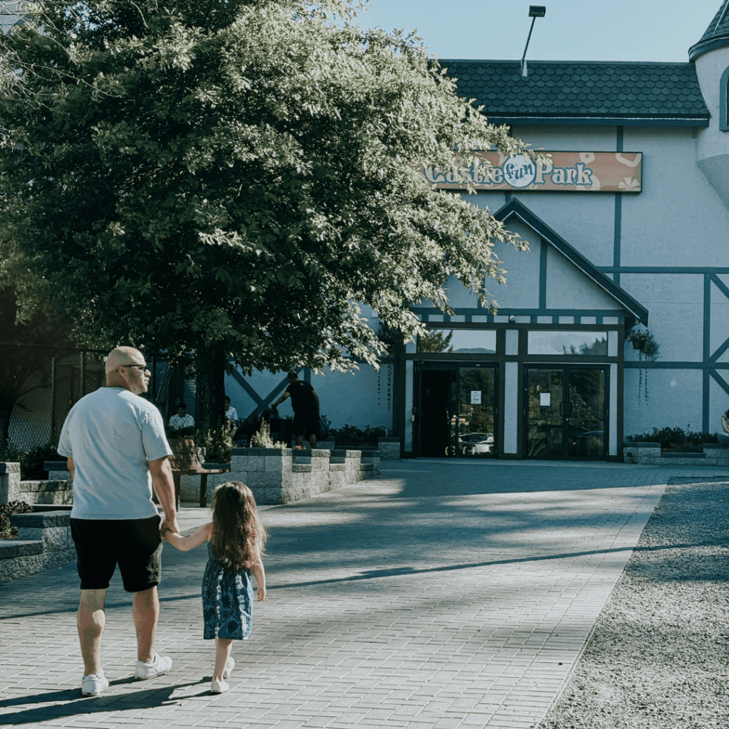 father and daughter walk up a patch