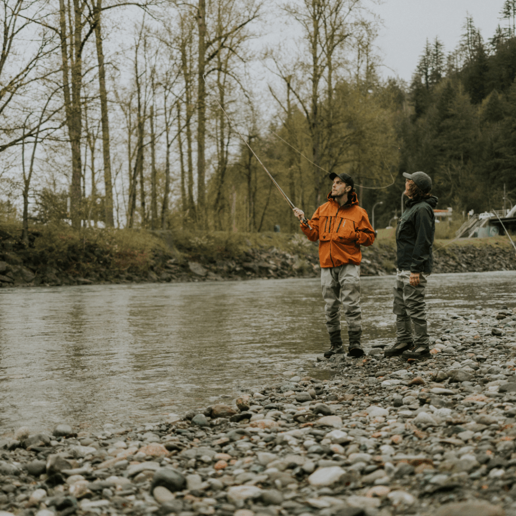 two people fishing in a river