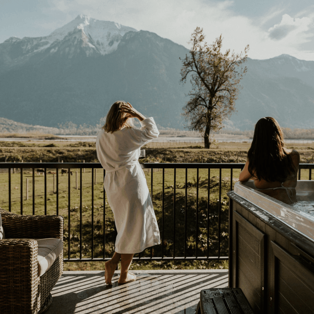 a woman on a balcony and a woman in a jacuzzi