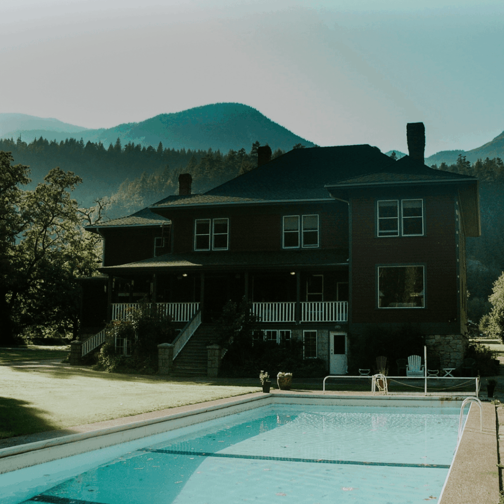 a pool in front of a lodge
