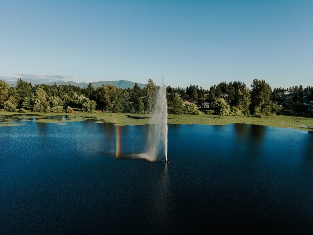 aerial photo of a fountain in a lake