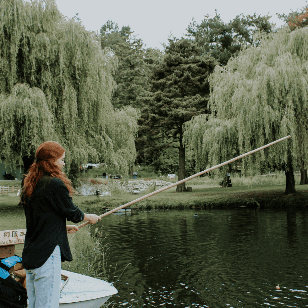 A woman fishing in a boat.