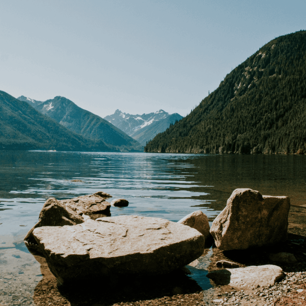 A body of water, surrounded by gorgeous mountains