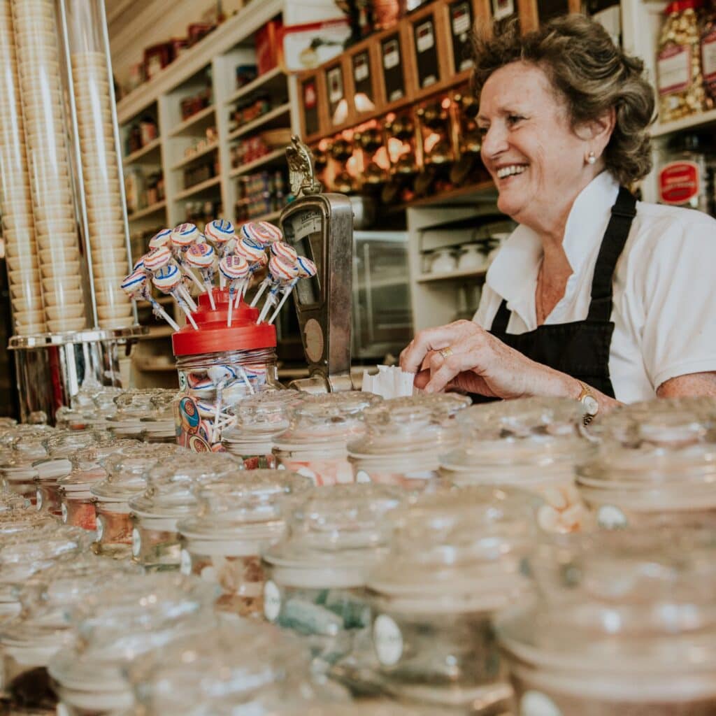 Woman behind a counter of a candy story