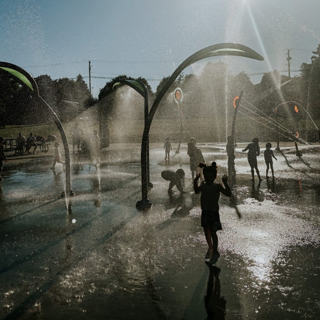 Children playing at a splash park on a hot summer day
