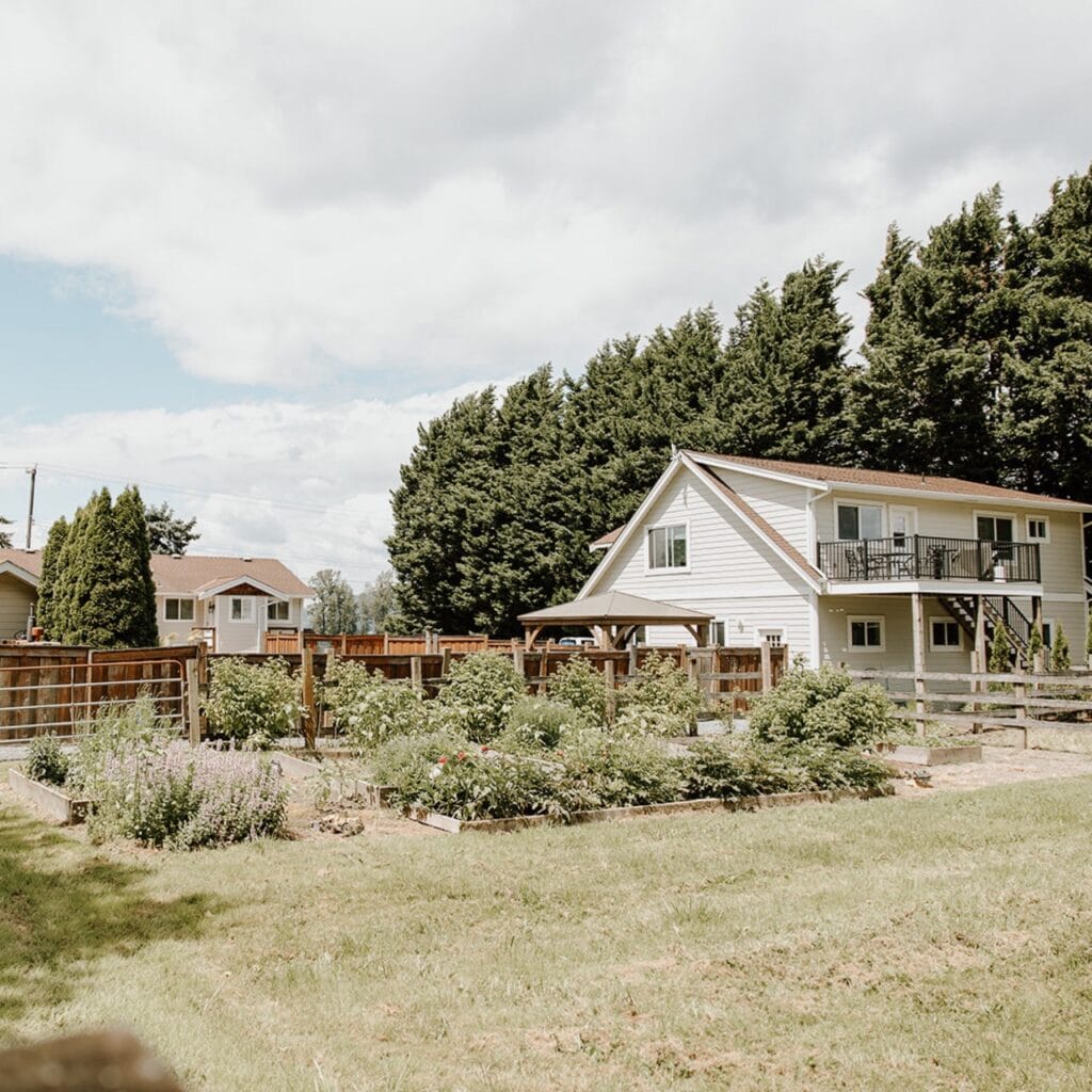 A house with a garden in the backyard.