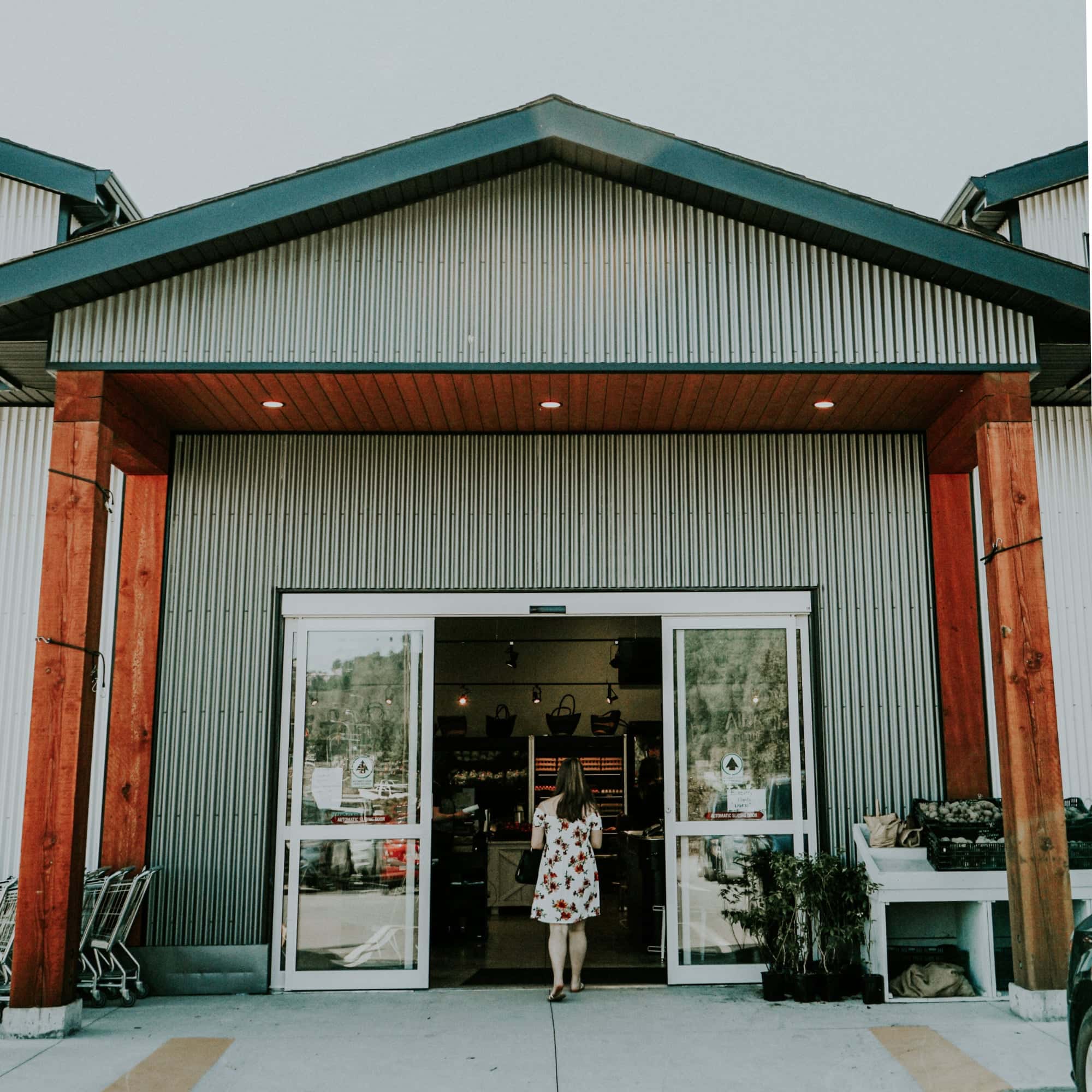 A woman walks into a shop