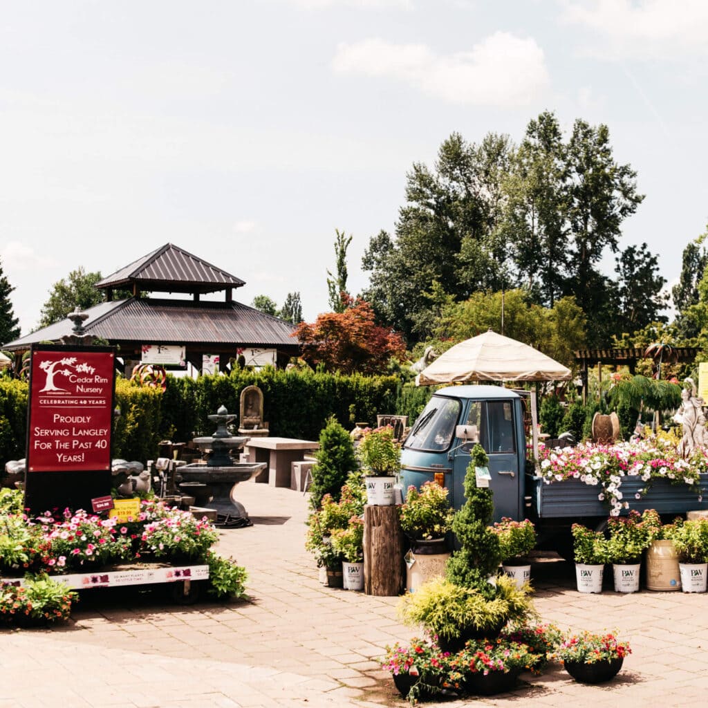 A flower shop with a decorative truck and a gazebo.