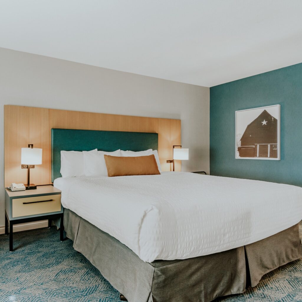 A large comfy looking bed in a hotel room
