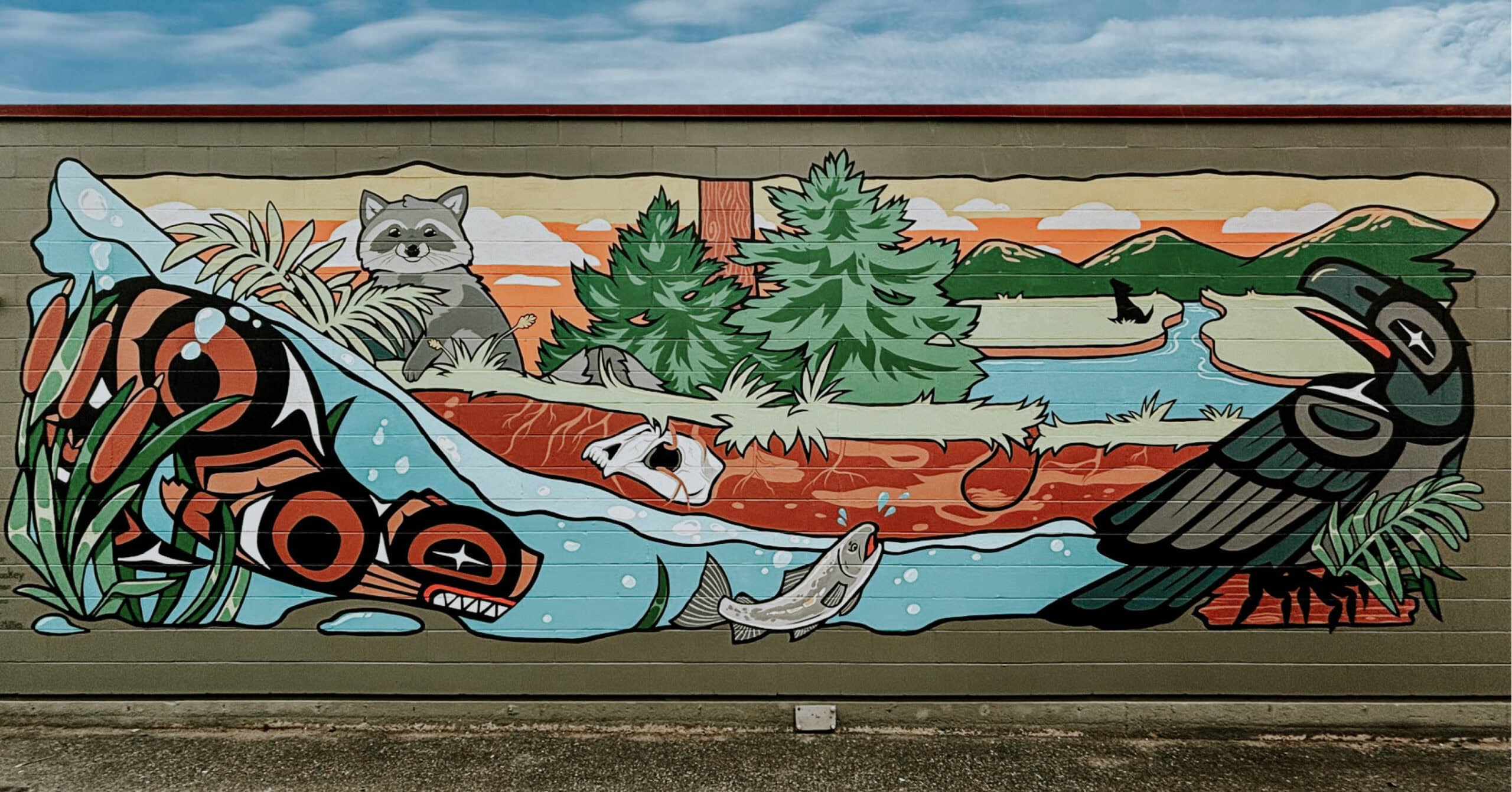 An Indigenous mural depicting a canoe, a bird, and a cat