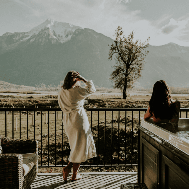 Two people looking out onto a mountain