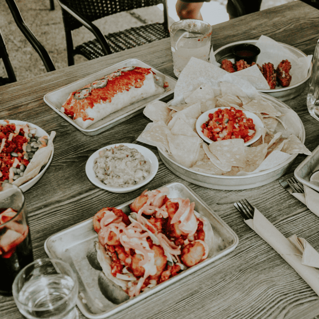 Table with multiple plates of Mexican cuisine
