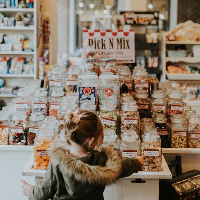Little girl looking at candy on display