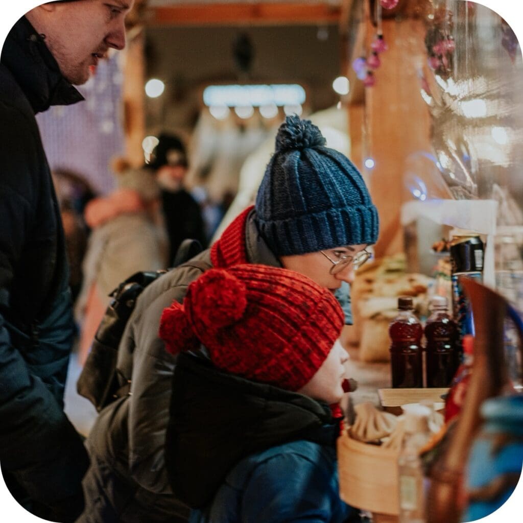 a couple of kids looking at a vendor's booth