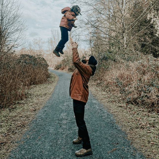 Little girl being thrown up in air by dad 