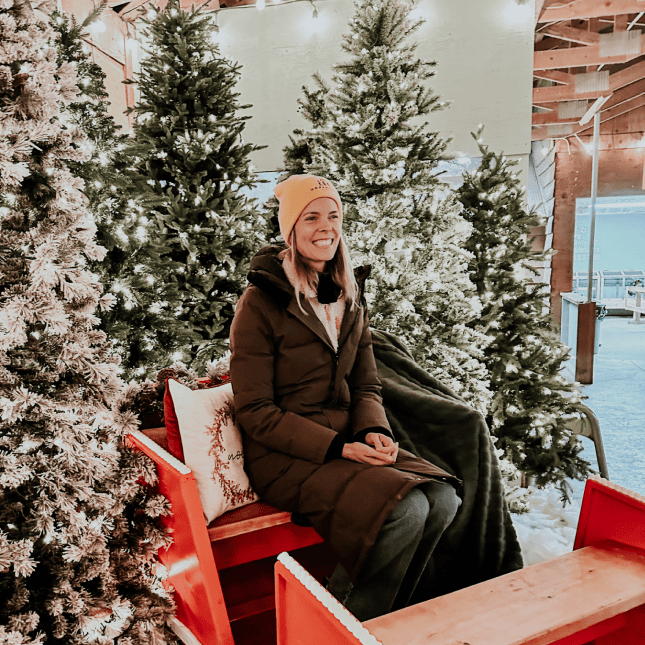 Woman sitting on a sleigh  smiling 