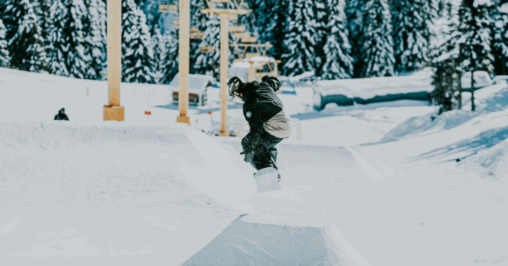 Man Hitting a jump on a snowboard