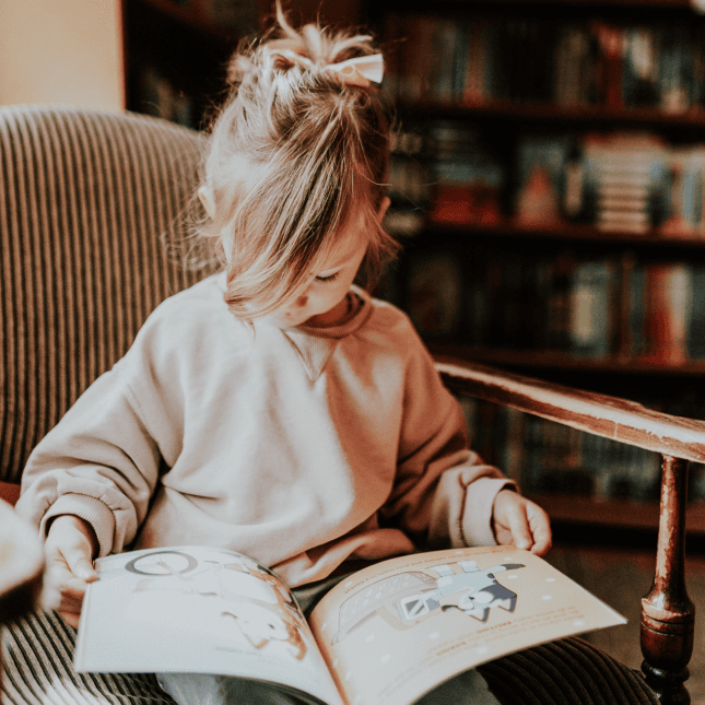 Little girl reading a book