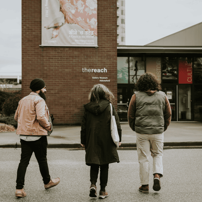 People walking towards a building 