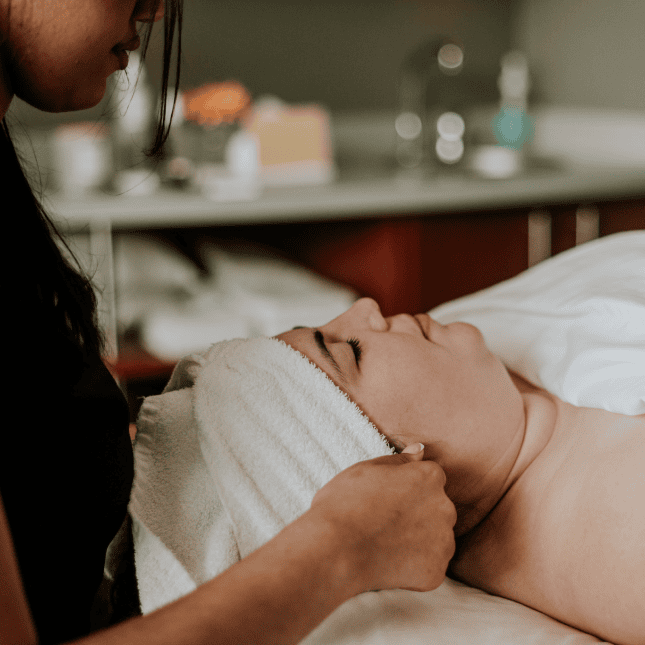 Women with eyes closed getting a beauty treatment 
