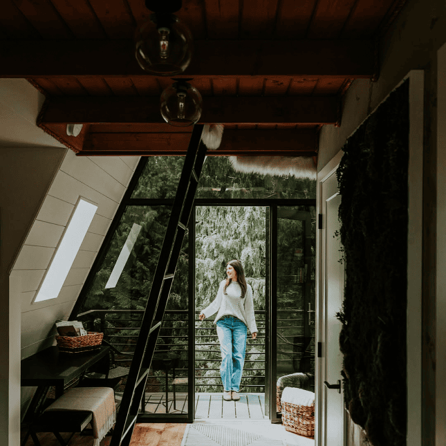 Inside of a tree house with woman standing in the doorway 