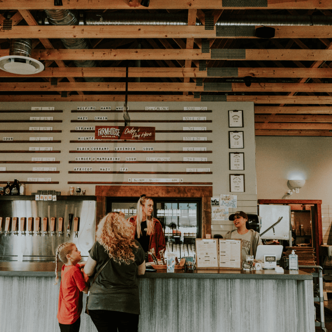 People ordering food at a till